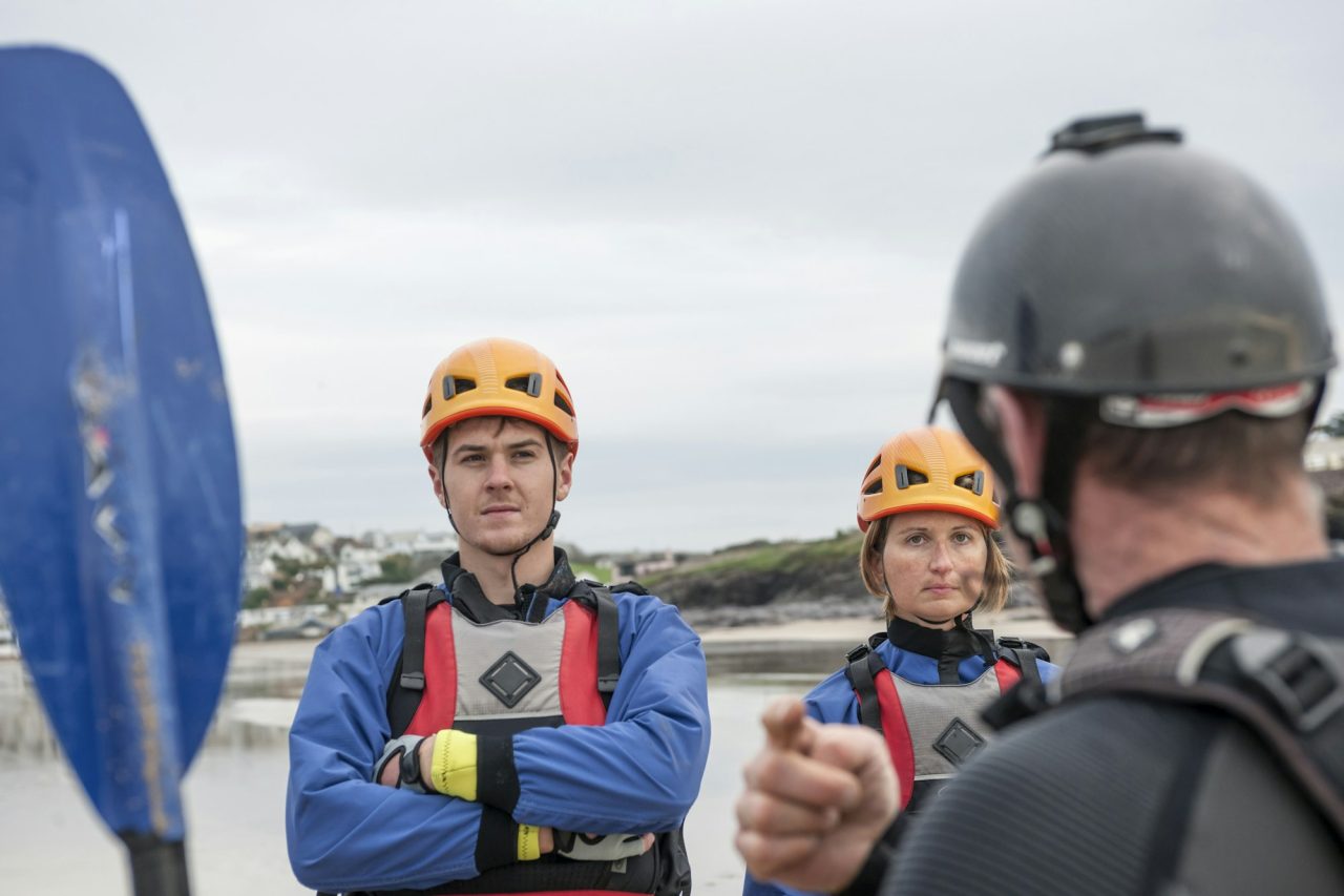 adventure-seekers-listening-intently-during-a-safety-briefing-before-a-water-sport-activity-.jpg