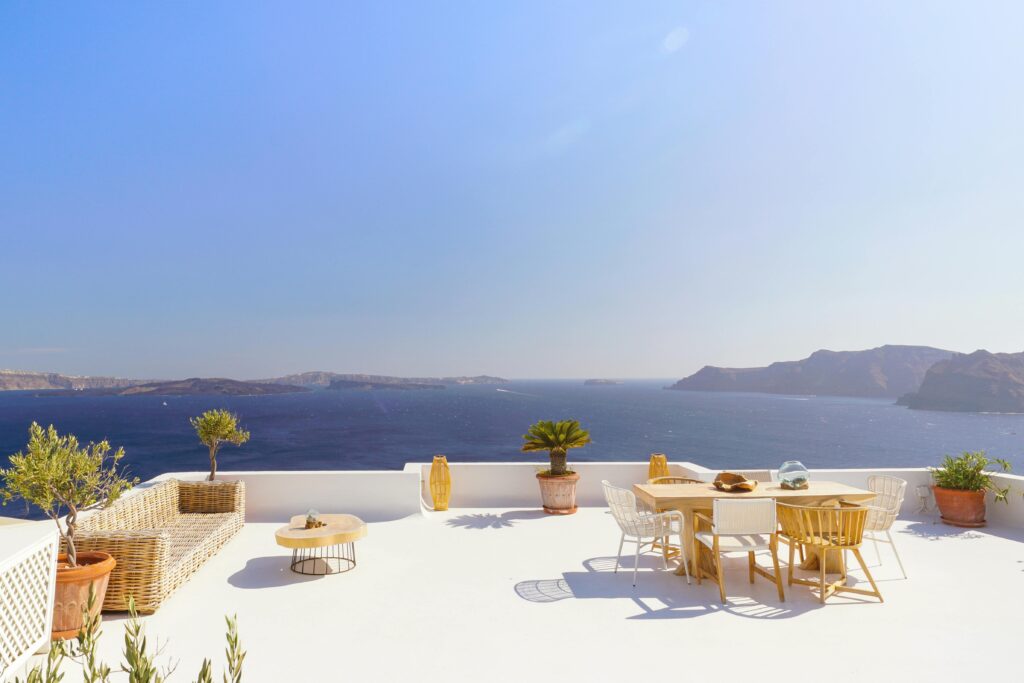 Elegant seaside patio with stunning views of Santorini. Perfect for summer relaxation.