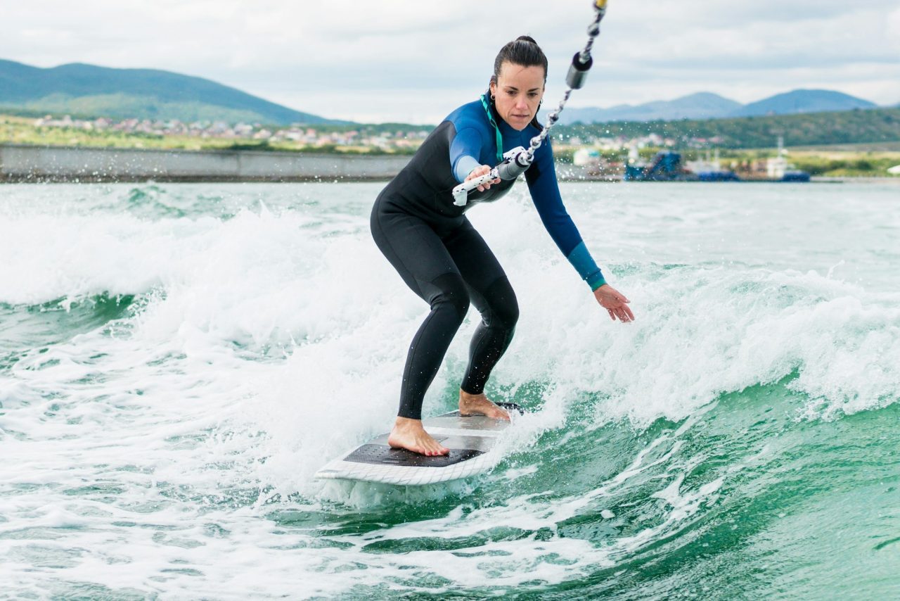watersport-concept-young-athletic-woman-learning-wakesurfing-and-perfecting-tricks-.jpg