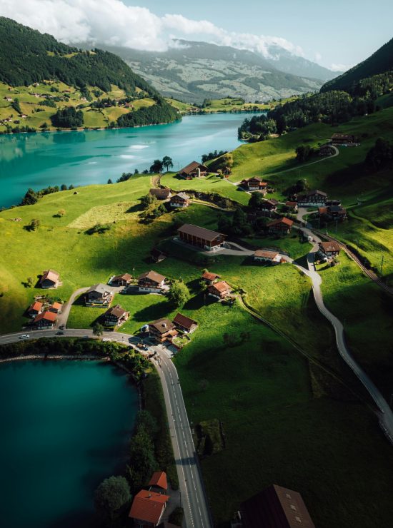 Breathtaking aerial shot of Lungern Lake and village in Switzerland surrounded by lush mountains.